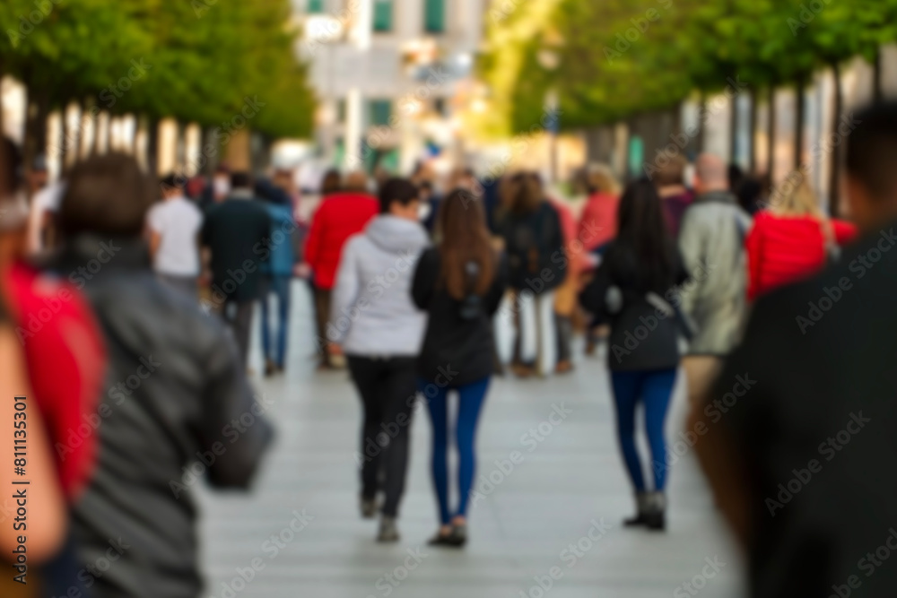 blurred for background. Crowd of people on the street. people walking on the city street. A blurry people walking. Urban, social concept. Abstract urban background with blurred buildings and street. blurred for background. Crowd of people on the street. people walking on the city street. A blurry people walking. Urban, social concept. Abstract urban background with blurred buildings and street.