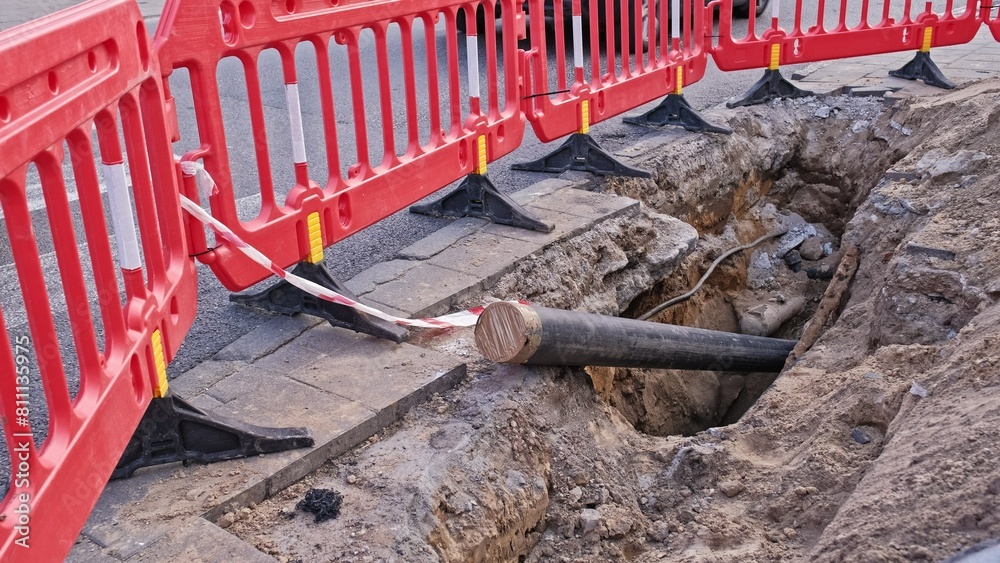 Gas PVC Pipe Exposed at Roadworks Construction Dig Site Secured with Temporary Red Safety Barrier