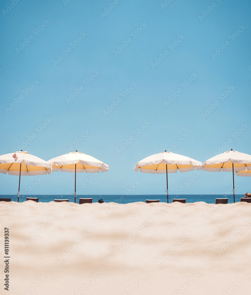 Serene Beach Escape with Sunny Umbrellas and Endless Blue Skies