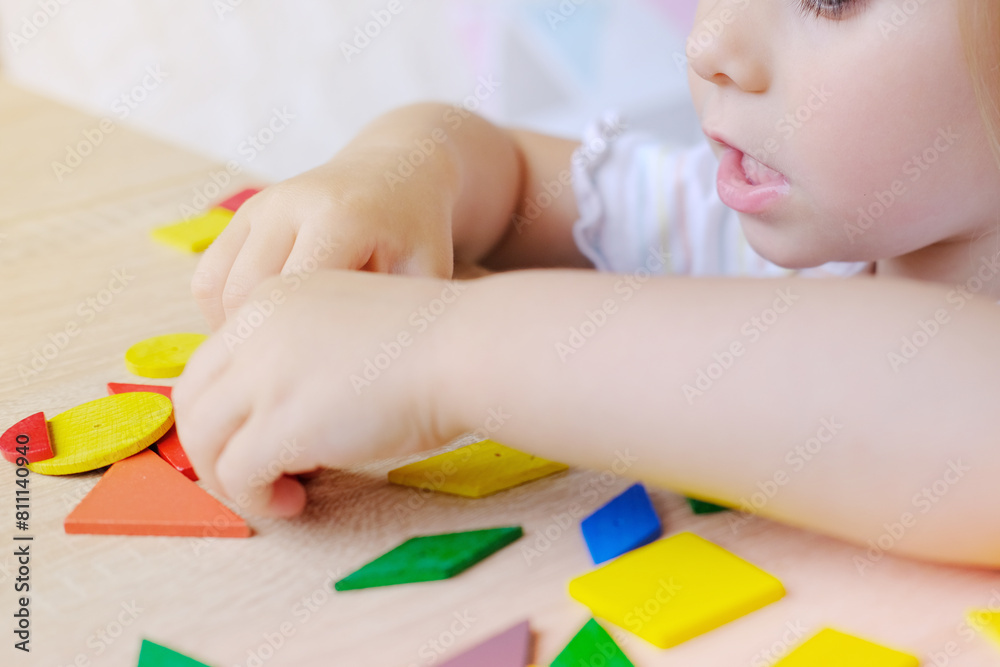 cute child, girl 3 years old plays with colored wooden geometric figures, counts details, concept of development of creativity, fine motor skills, patience perseverance, children's entertainment cute child, girl 3 years old plays with colored wooden geometric figures, counts details, concept of development of creativity, fine motor skills, patience perseverance, children's entertainment