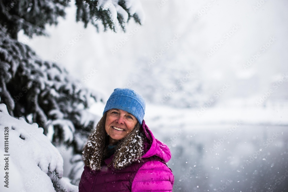 A portrait of a very happy middle aged woman on a cold snowy day in Colorado, USA A portrait of a very happy middle aged woman on a cold snowy day in Colorado, USA