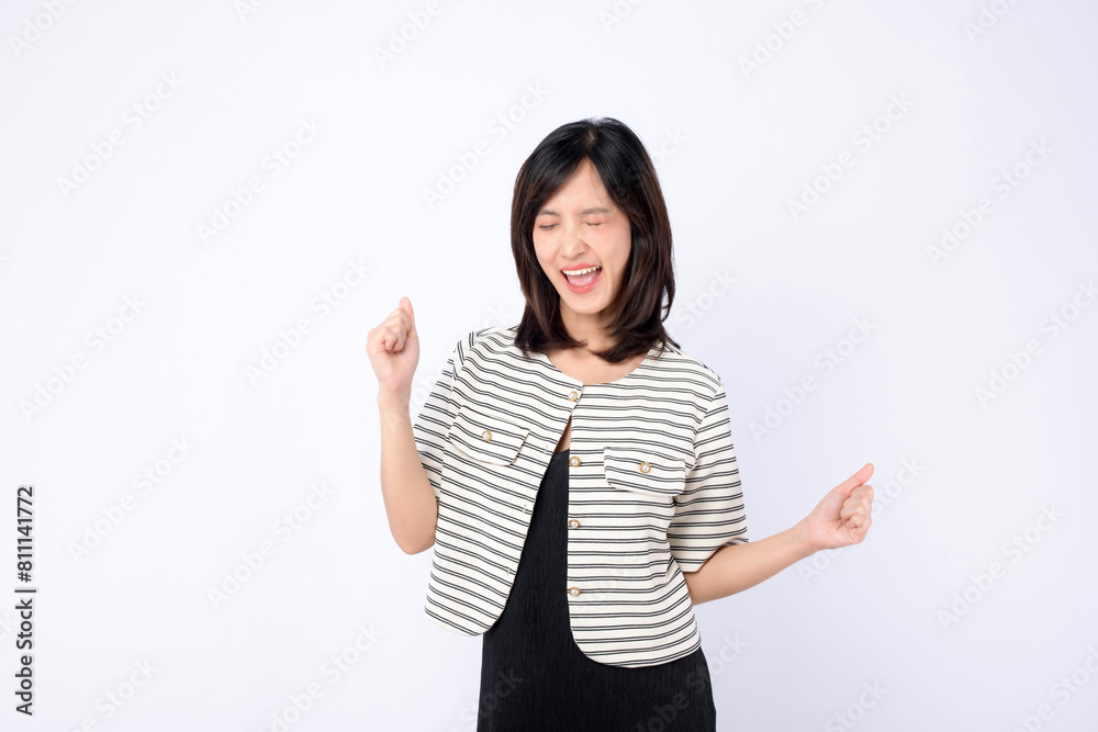 Asian woman is posing with an expression of joy against a white background. Asian woman is posing with an expression of joy against a white background.