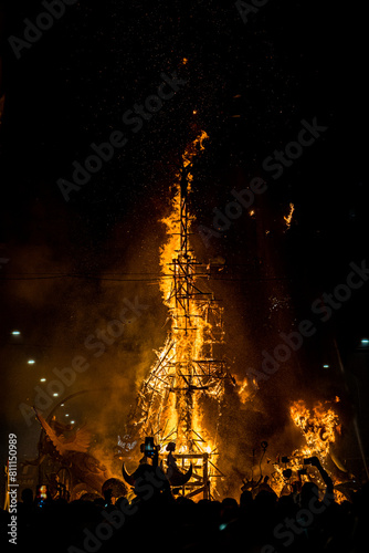 Vertical image of a wooden structure in flames during the celebration of St. John's Eve, June 24, where they burn of the bonfires.