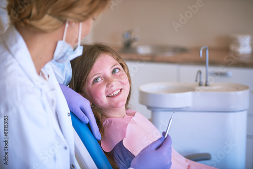 Smile  girl and dentist with dental checking with oral hygiene and teeth care with patient and mouth exam. Toothache  cleaning and medical help with kid doctor and dentistry tool for healthcare