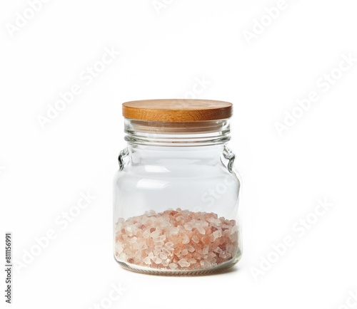 Himalayan pink salt in glass jar isolated on white background. Gourmet salt - red himalayan variety