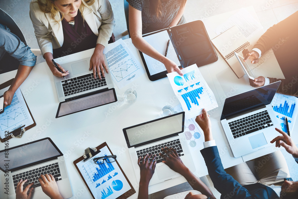 © peopleimages.com - Laptop, paperwork and business people in teamwork with charts, graphs or statistics for productivity growth. Data analysis, men and women with tech for performance, development or coworking in office