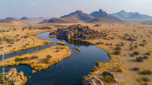 Aerial View of Meandering River Through Barren Desert Landscape