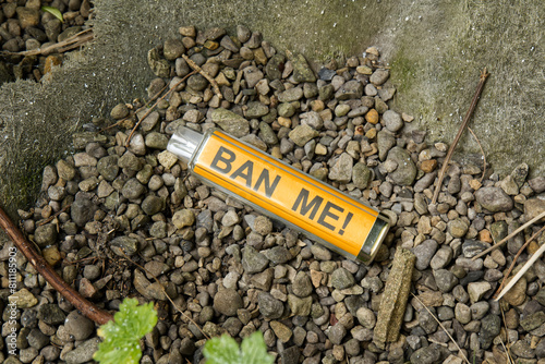 A discarded vape mock-up with the words 'BAN ME' written on the inside shell.