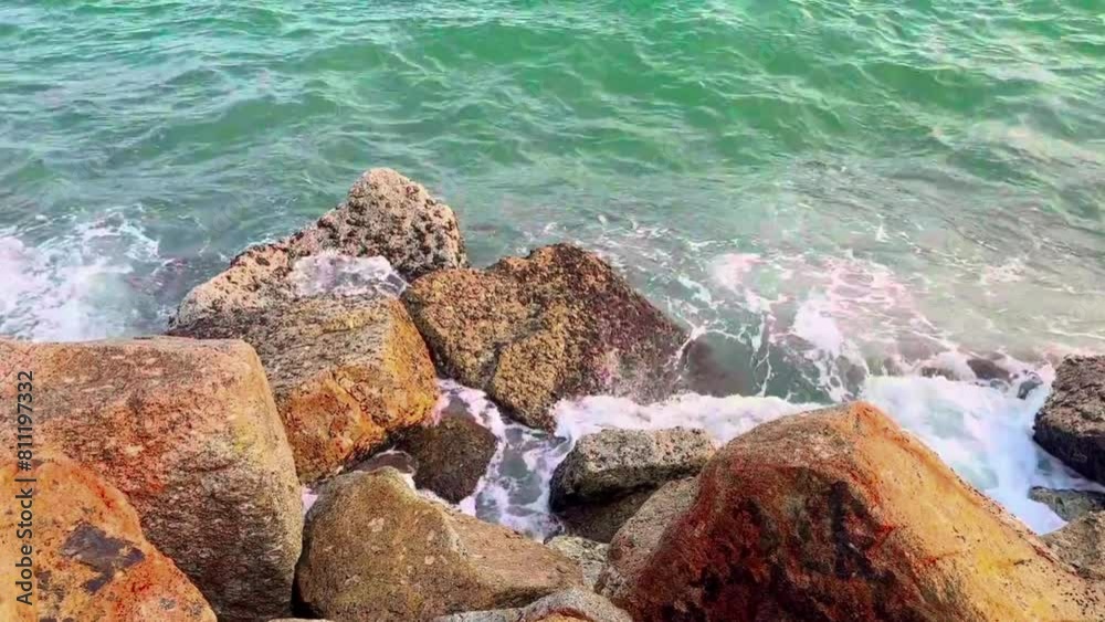 The ocean waves hit the rocks hard on the beach. Seaspray splashes into the sky in the evening. Seascape. - vedio