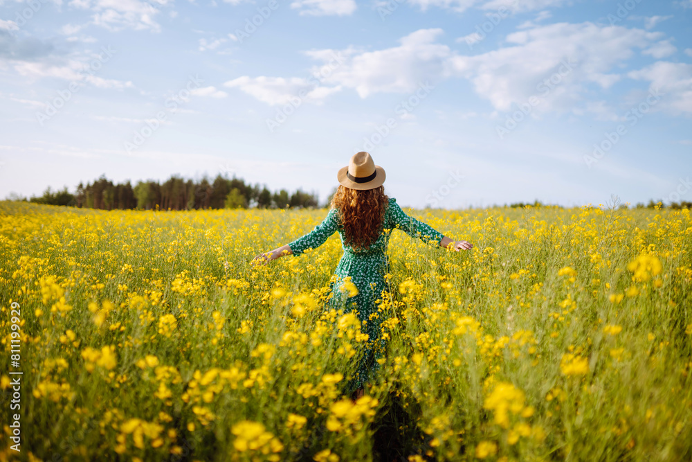 Beautiful woman walks run along yellow field rapeseed. Nature, fashion, summer lifestyle. Beautiful woman walks run along yellow field rapeseed. Nature, fashion, summer lifestyle.