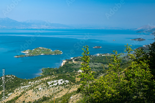 Fototapeta Naklejka Na Ścianę i Meble -  Viewpoint Donji Muriсi. Beautiful summer landscape of small green islands and blue waters of Lake Skadar near the border with Albania. Montenegro.