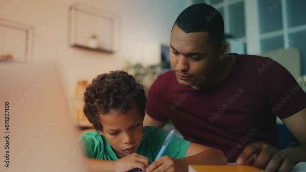 African American dad assists diligent son with homework, providing support African American dad assists diligent son with homework, providing support