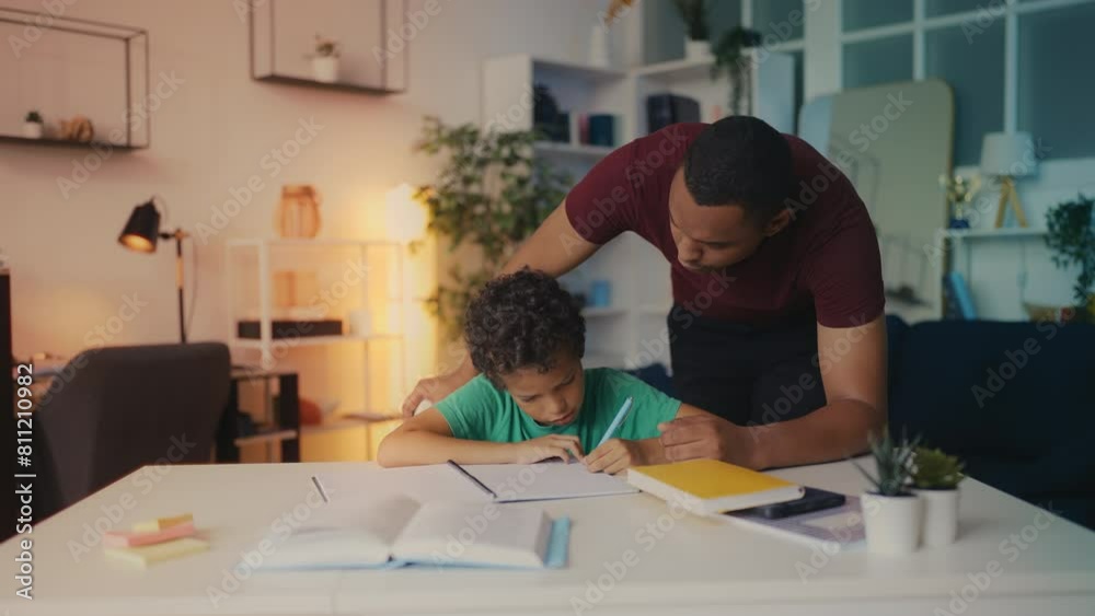 Father scolds his son during homework, too much academic pressure on a child Father scolds his son during homework, too much academic pressure on a child