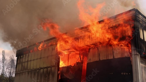 Large fire in a large building - flames engulfing the roof