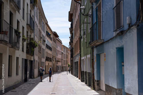 Couple of pilgrims on the main street of Villava. Way of St. James. Navarre. Zubiri-Pamplona Stage