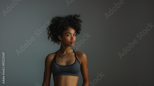 Attractive black woman with a fashionable hairstyle in stylish sportswear. Fashion and beauty, active lifestyle and sports.