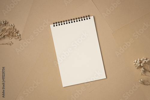 Quadro su tela Empty notebook on sheets of paper background from above