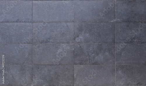 Dark gray horizontal stone tiles for ventilated facade cladding. Background and texture © luca piccini basile