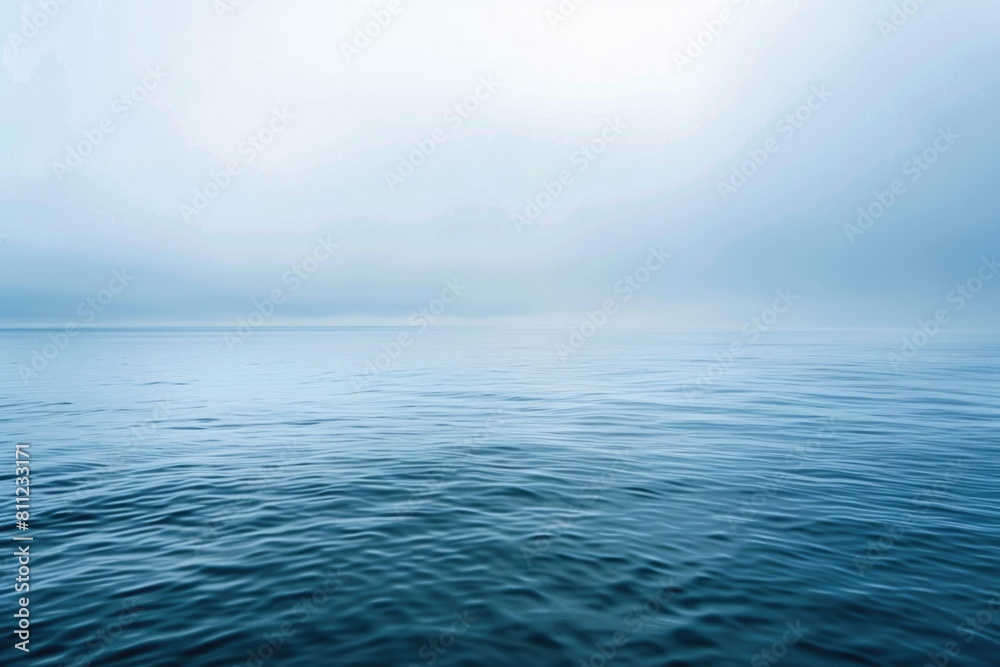 Tranquil Blue Sea. Calm Ocean Landscape with Hazy Background and Cloudy Sky over Horizon