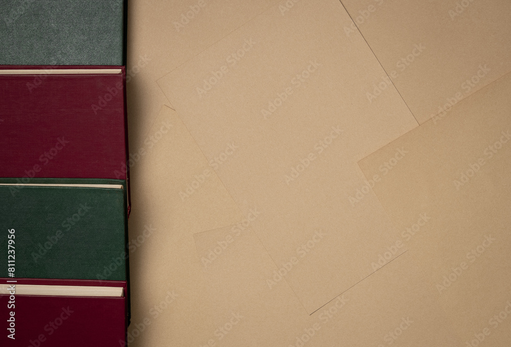 Sheets of paper background with books. Vintage. Flat lay, top view. Copy space