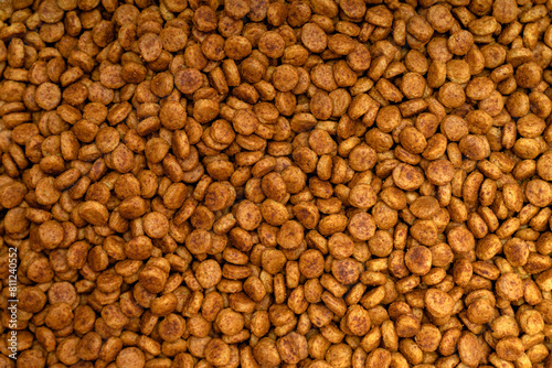 Food for animals background. Dry cat and dog food texture  pattern. Pet meal background close up. Dry food for pet dogs and cats. Dried pet food top view. Granules of good nutrition for dogs and cats.