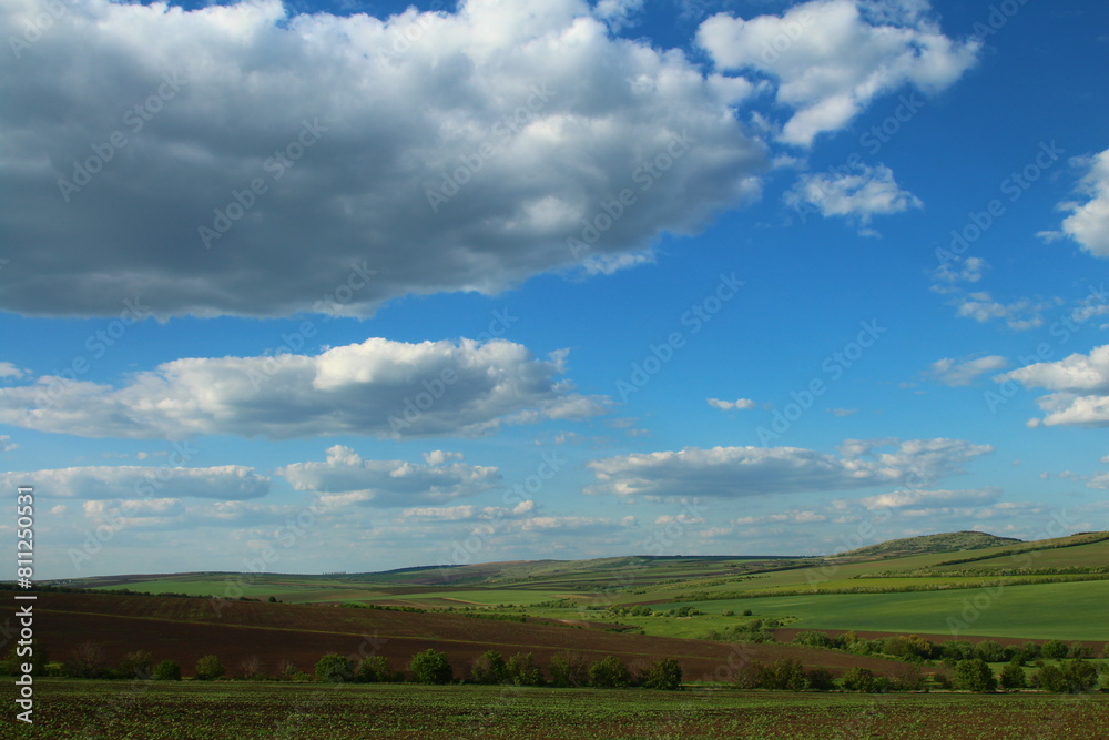 A landscape with a blue sky and clouds A landscape with a blue sky and clouds