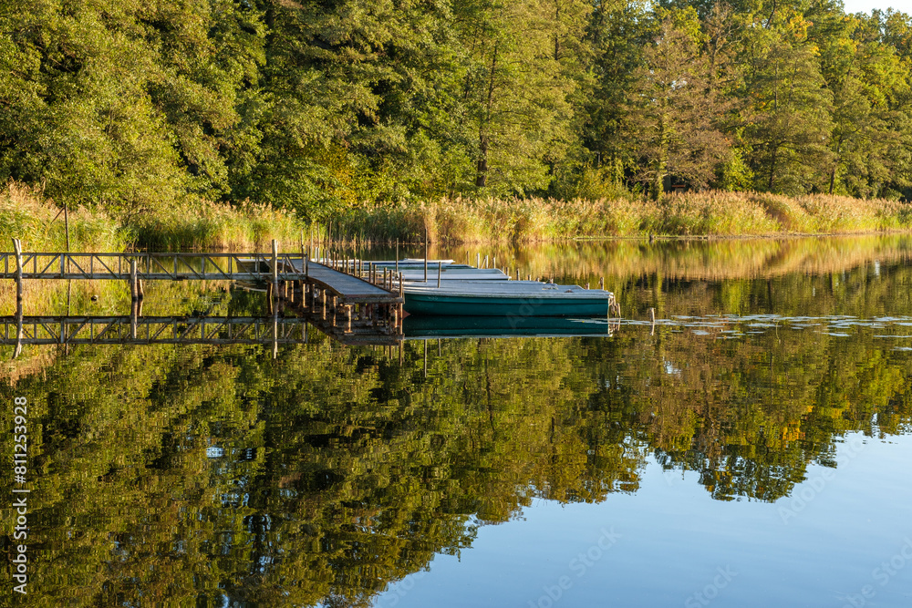 Natural landscape of the lake, high definition, the movement of waves against the background of the autumn forest. The reflection of clouds on the ripples of water. Germany.
