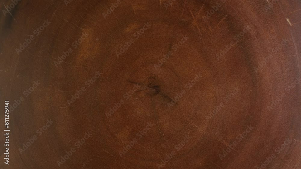 Old Ash tree rings texture close up. Wooden circle stump trunk background from top view. Cross section cut tree trunk with age tree rings wood and counter clockwise rotation.
