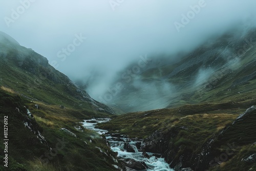 A stream winds its way through a vibrant green valley surrounded by misty mountains  A misty mountain range shrouded in fog with a gentle stream running through the valley