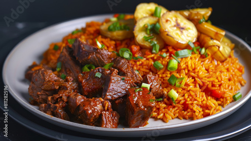 Authentic ghanaian jollof rice served with succulent beef stew and fried plantains on a white plate against a dark background