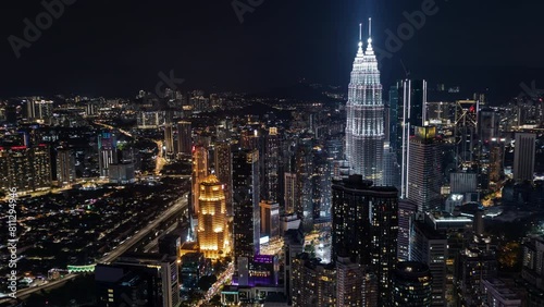 Aerial night view of Kuala Lumpur with the illuminated Petronas Towers standing prominently photo