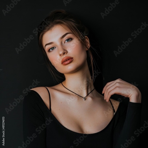 Stylish Young Woman Exuding Confidence with a Poised Pose against a Sleek Black Backdrop