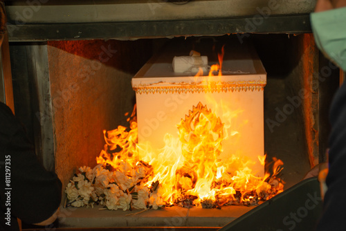 Obraz na plátně A fire at a crematorium with paper flower-fueled flames.