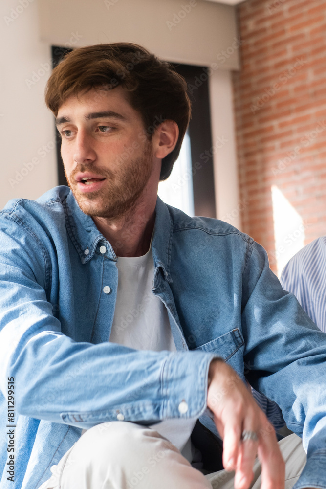 Obraz premium Close-up of a young couple sitting apart discussing having relationship problems, thinking about breakup or divorce. Family lovers, distraught men and women, avoid talking and suffer from betrayal