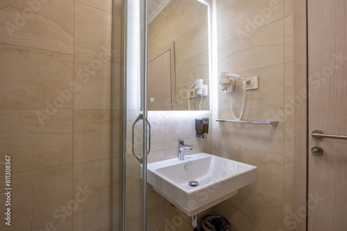 Interior of a hotel bathroom with glass bathroom