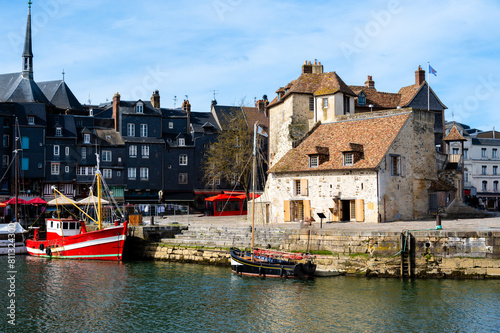 Harbor of Honfleur with the old pier, the Lieutenance house and 2 fishing boats, Normandy, France