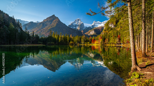 Fototapeta Naklejka Na Ścianę i Meble -  Serene Autumn Morning at Schiederweiher, Upper Austria with Vibrant Foliage and Mountain Reflections