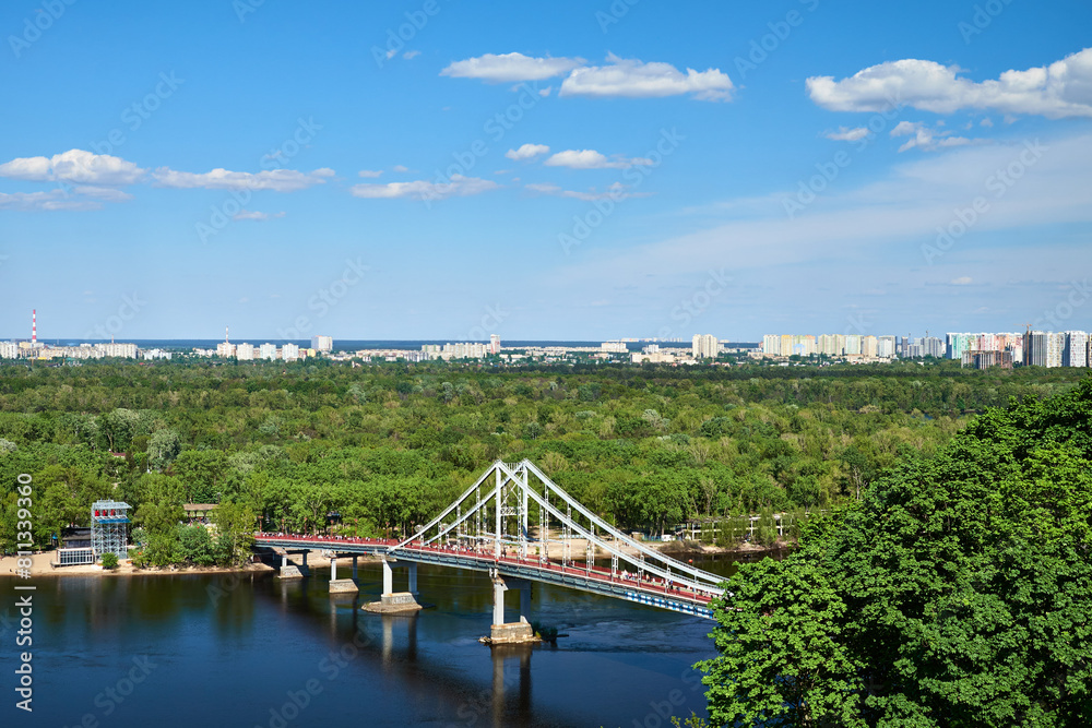 Fototapeta premium Top view of the Dnipro River and the pedestrian bridge to Trukhanov Island in Kyiv, Ukraine.