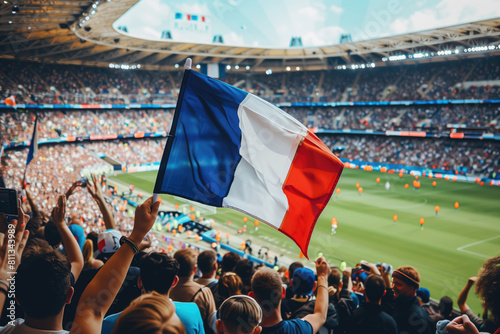 Excited sports spectators holding French flag on a sports stadium in France.