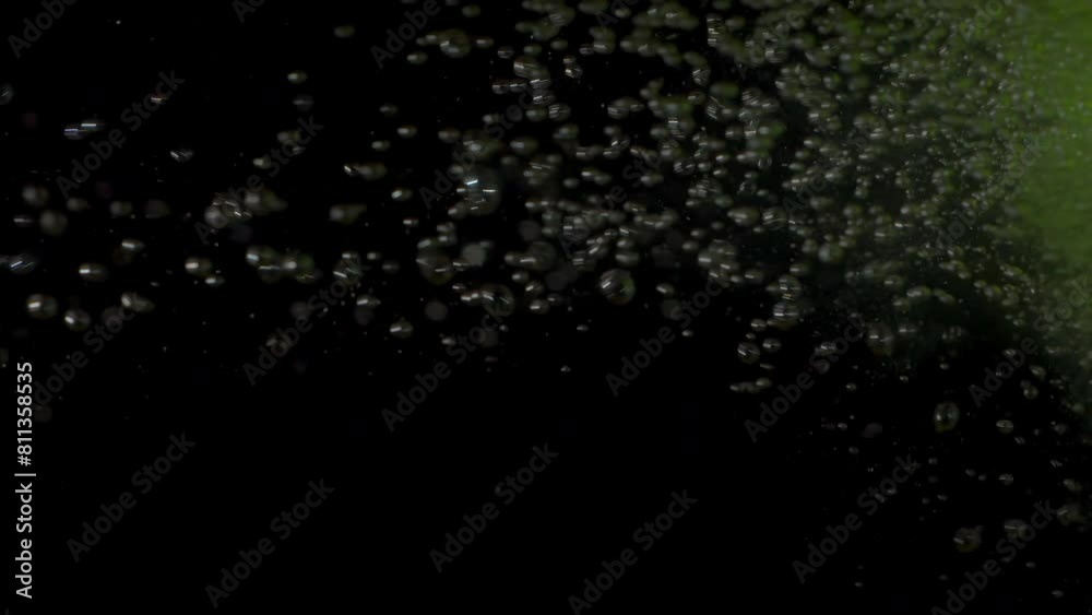 A green bath bomb falls into the water, dissolving and releasing effervescent bubbles and a vibrant hue. A green bath bomb falls into the water, dissolving and releasing effervescent bubbles and a vibrant hue.