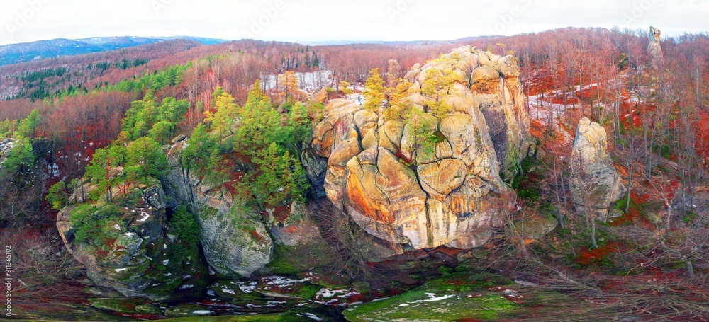 Dovbush rocks in winter in Bubnyshche, Carpathians, Ukraine, Europe. Huge stone giants rise in the snowy transparent beech forest, all-round panoramic views are unique without leaves