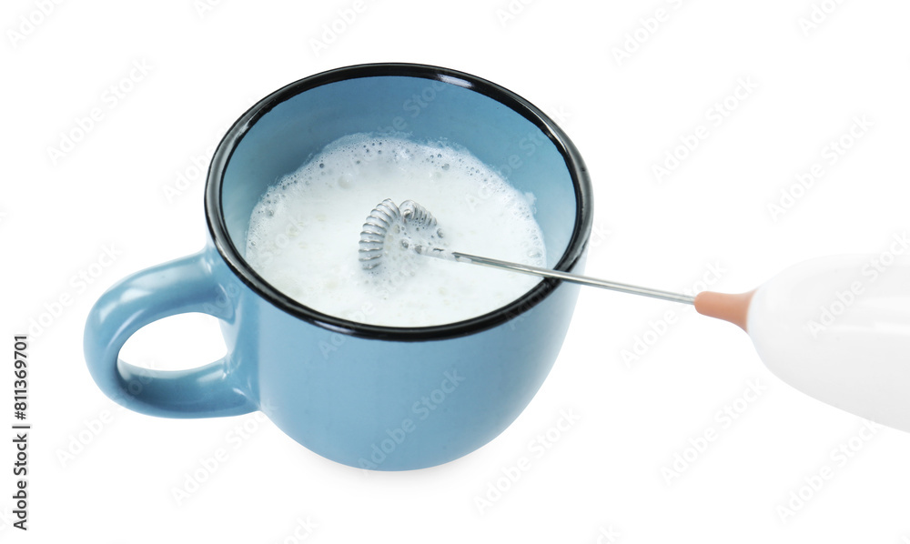Whisking milk in cup with mini mixer (frother wand) isolated on white, closeup