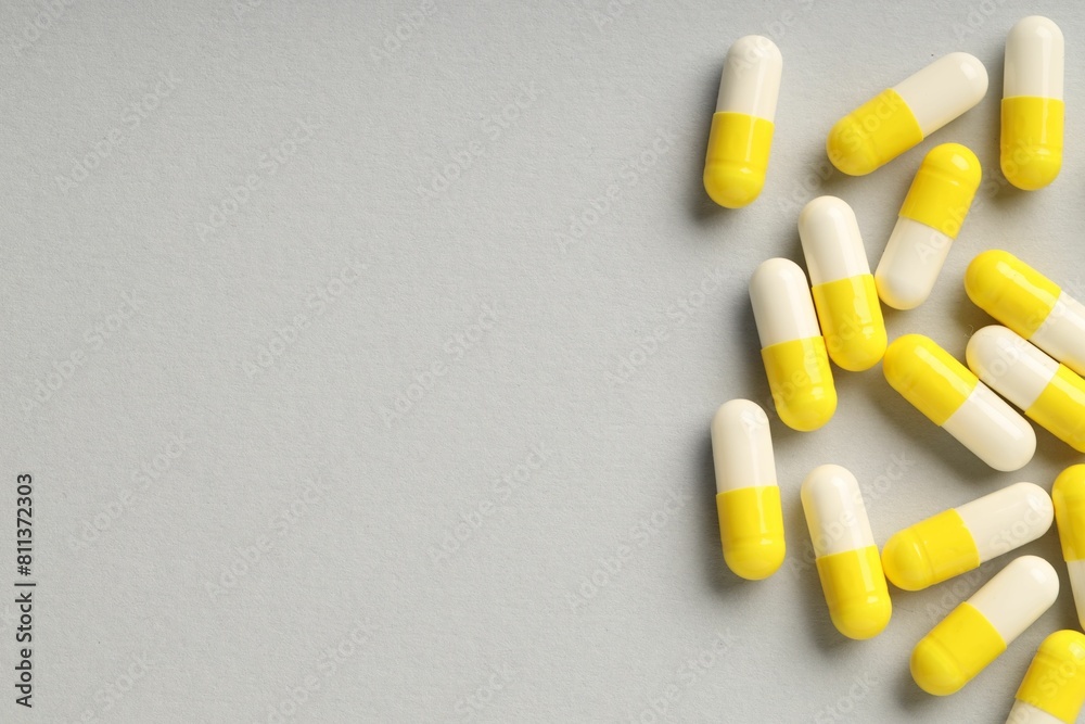 Many antibiotic pills on grey background, top view and space for text. Medicinal treatment Many antibiotic pills on grey background, top view and space for text. Medicinal treatment