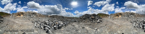 Carpathian Mountains of Ukraine, a quarry where granite sandstone is mined for the production of building materials, powerful trucks and conveyors load gravel - video from a drone