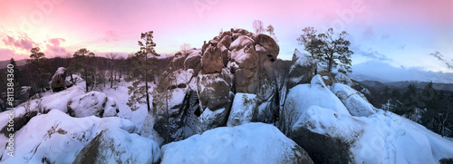 Dovbush rocks in winter in Bubnyshche, Carpathians, Ukraine, Europe. Huge stone giants rise in the snowy transparent beech forest, all-round panoramic views are unique without leaves photo