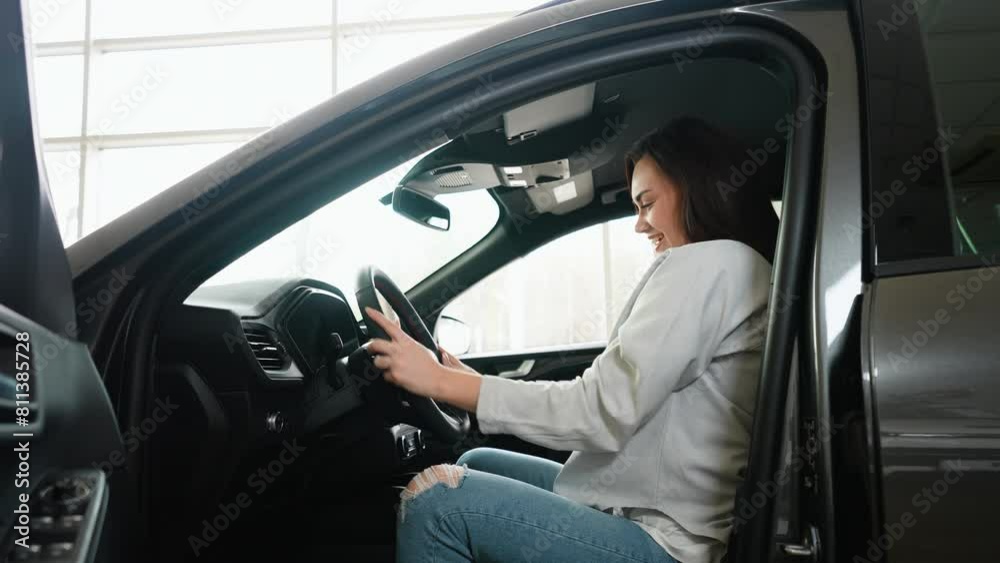 Beautiful woman rejoices in buying a new car Beautiful woman rejoices in buying a new car