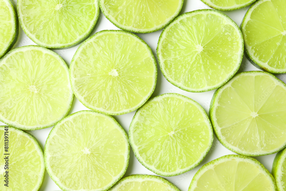 Fresh juicy lime slices on white background, flat lay Fresh juicy lime slices on white background, flat lay
