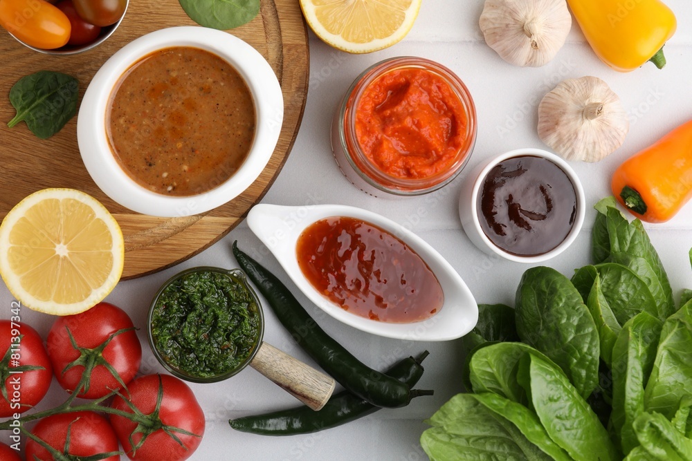 Different marinades and products on white tiled table, flat lay Different marinades and products on white tiled table, flat lay