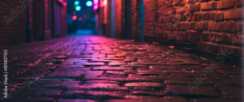 Neon-lit wet cobblestone alley at night photo