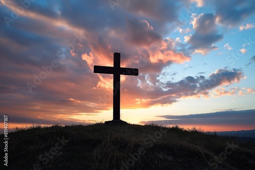 A solitary cross stands against a tumultuous sunset sky, symbolizing faith and hope